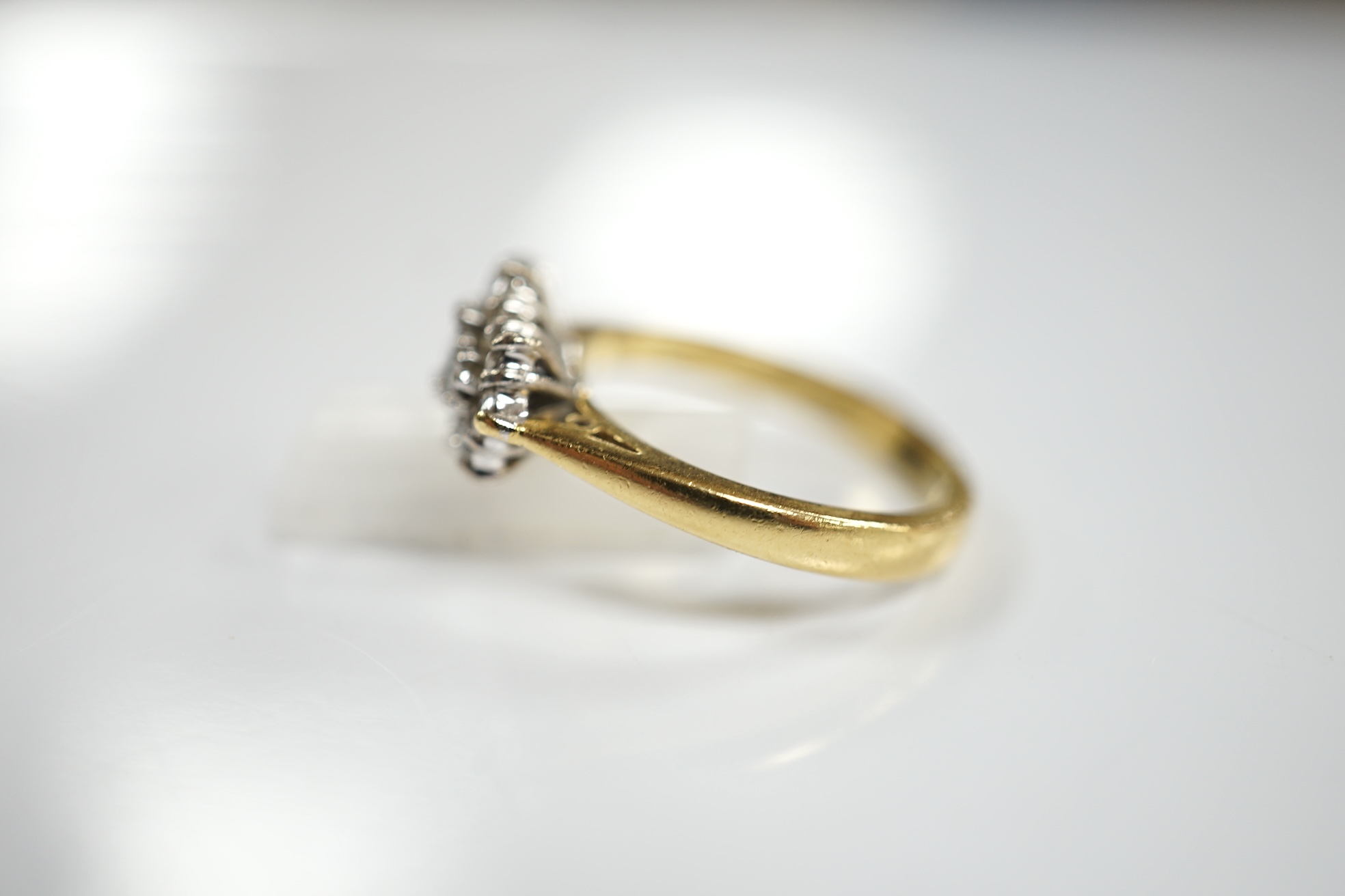 A modern 18ct gold and diamond cluster ring, size K, gross weight 4.4 grams. Condition - fair to good